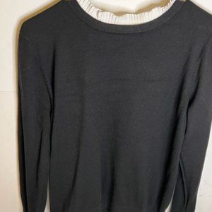 Black Sweater with a white Ruffled Collar and cuffs